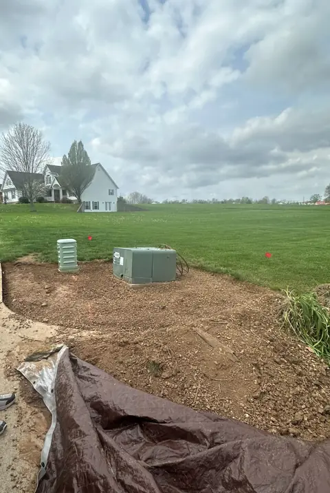 Corner bed during installation, with prepared soil around utility boxes